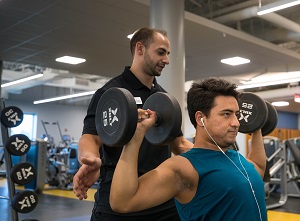 Harper College personal trainer Joe Mago works with client