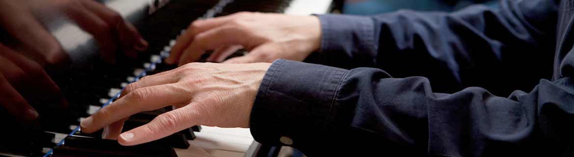 Hands playing the piano