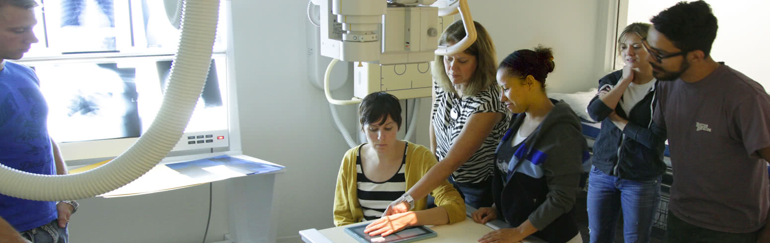 Woman getting hand examine with professionals using radio logic technology
