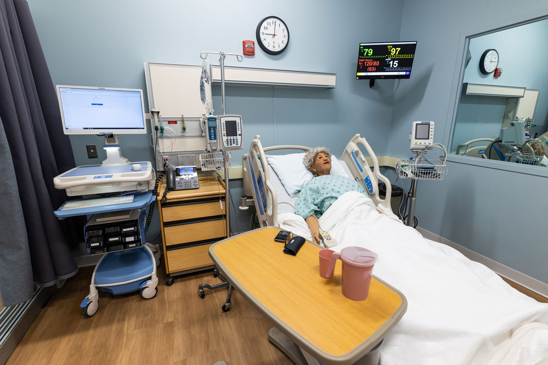 simulation hospital room with a dummy patient lying in bed