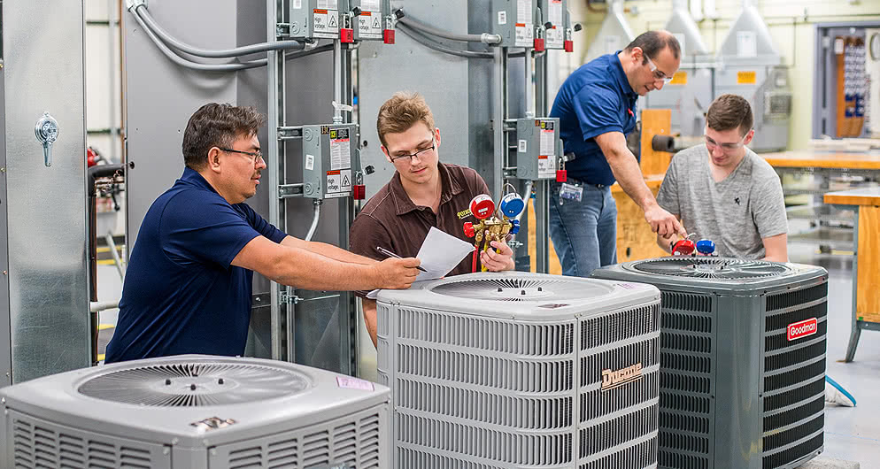 Group of people working with ventilation machinery