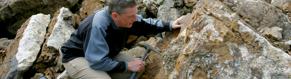 Man working with rocks and minerals in a geological setting
