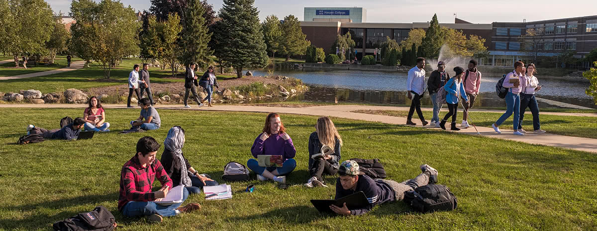 Students sitting on campus lawn