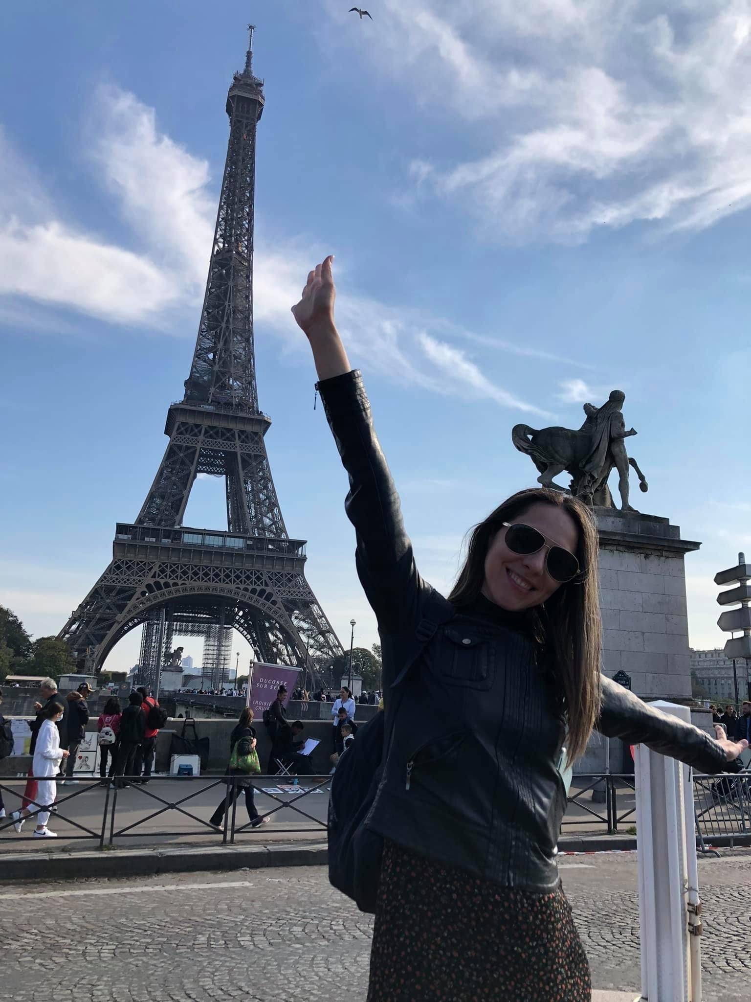 photo of Angelica standing in front of the Eiffel Tower